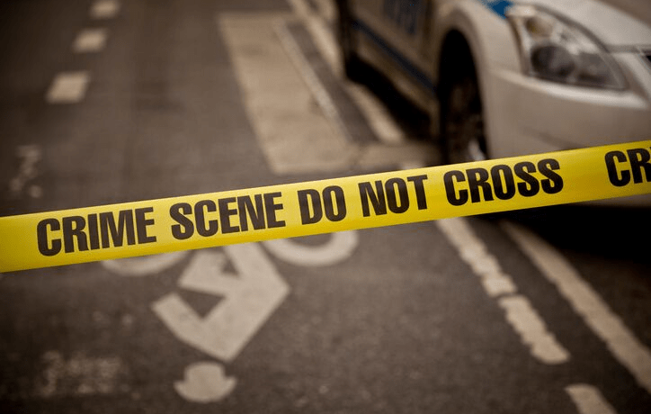 Crime scene tape blocking off a road