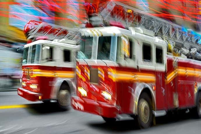 A photo of firetrucks driving to a fire