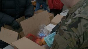 Woman from Indiana National Guard packing food