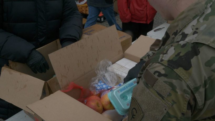 Woman from Indiana National Guard packing food