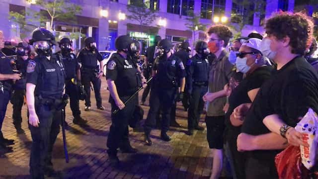 Cops and protesters confront each other