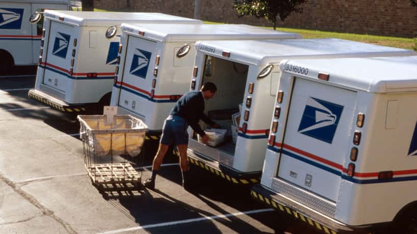 US Post Office, mail carrier loading truck.