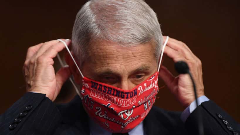 Dr. Anthony Fauci, director of the National Institute for Allergy and Infectious Diseases, lowers his face mask before testifying at a hearing of the Senate Health, Education, Labor and Pensions Committee on June 30, 2020 in Washington, DC. The committee is examining efforts to contain the Covid-19 pandemic while putting people back to work and kids back in school. (Photo by Kevin Dietsch-Pool/Getty Images)