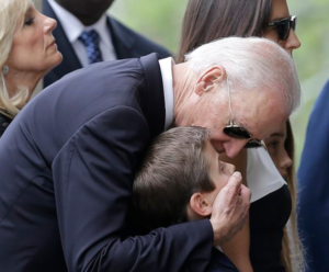 Former Vice President Joe Biden Covers the Mouth of a child.