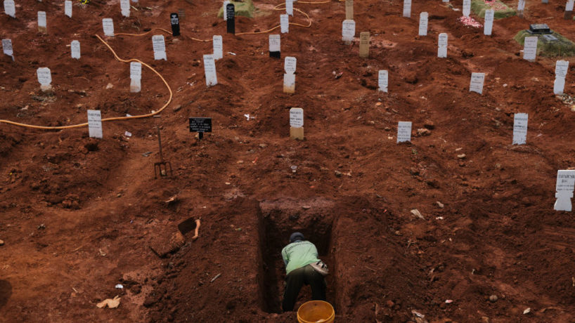 Man digging a grave in Indonesia