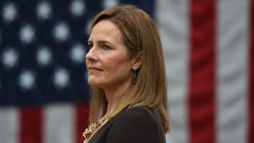 Judge Amy Coney Barrett in front of an American flag