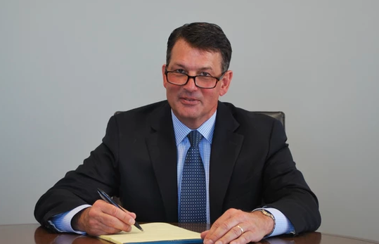 Jonathan Weinzapfel sits at a desk