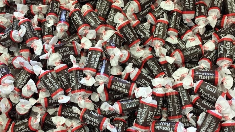 Hundred of Tootsie Roll candies sits in a pile for sorting
