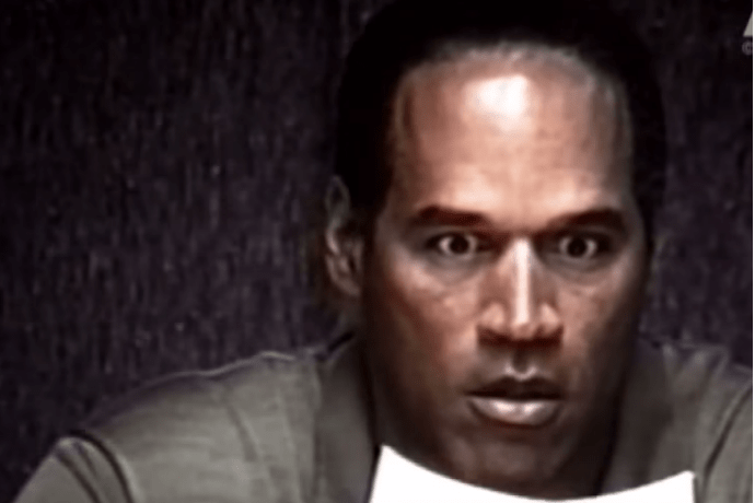 OJ Simpson Expresses Shock as He Looks at a Photograph