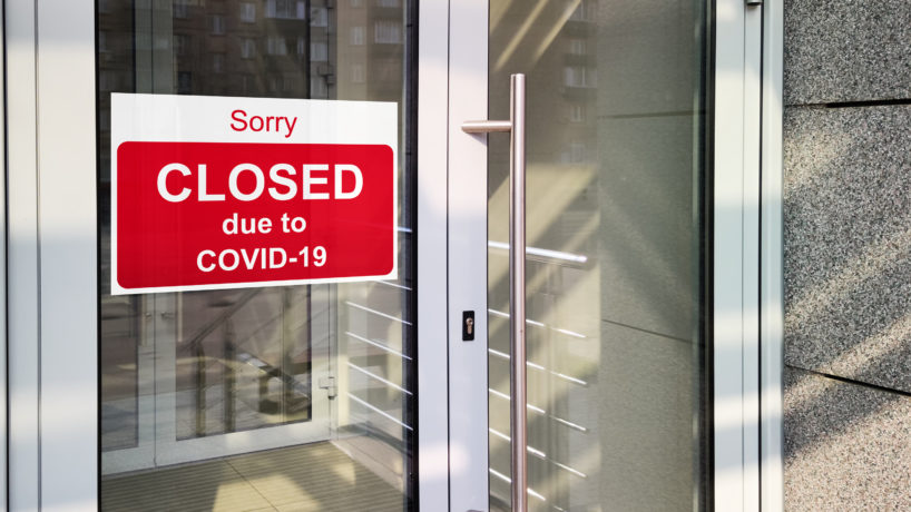 Business center closed due to COVID-19, sign with sorry in door window. Stores, restaurants, offices, other public places temporarily closed during coronavirus pandemic. Economy hit by corona virus.