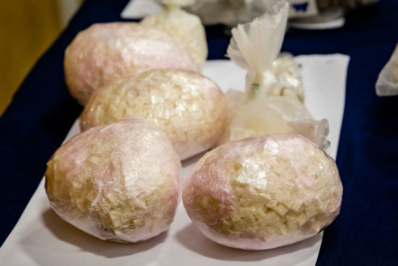 Bags of Crack Cocaine in small bags sits upon a table.
