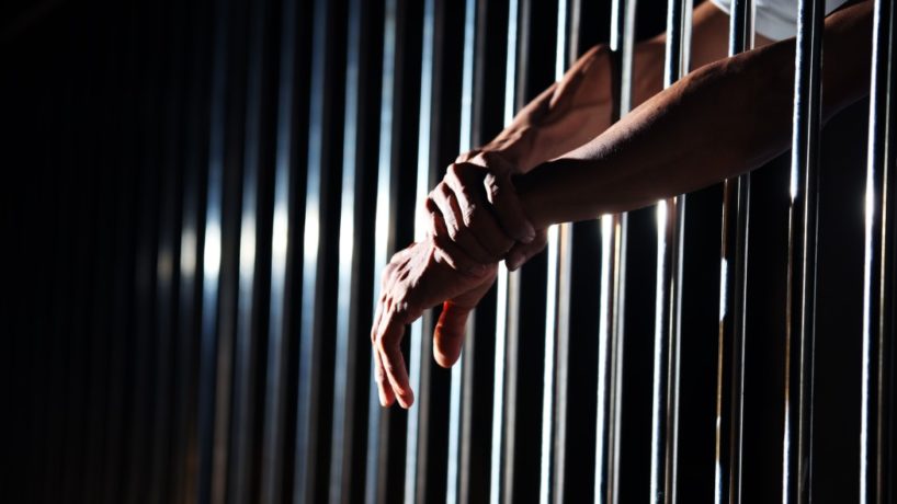 close up of hand in jail background.