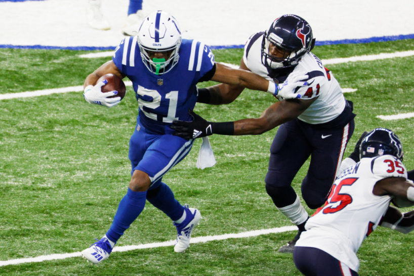Nyheim Hines running from a Texans defender
