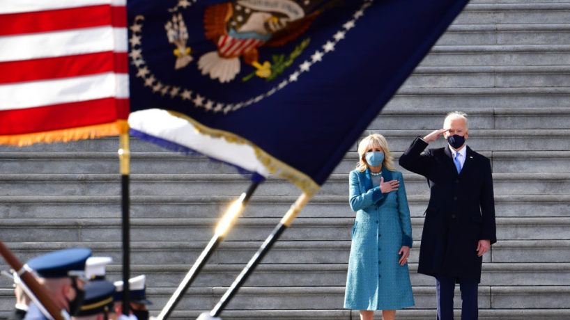 Joe Biden saluting military flags