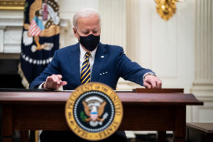 President Joe R. Biden signs executive orders in the State Dining Room at the White House on Friday, Jan 22, 2021 in Washington, DC.