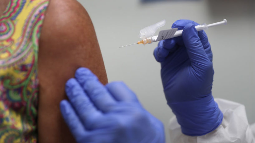 Lisa Taylor receives a coronavirus vaccine from RN Jose Muniz.