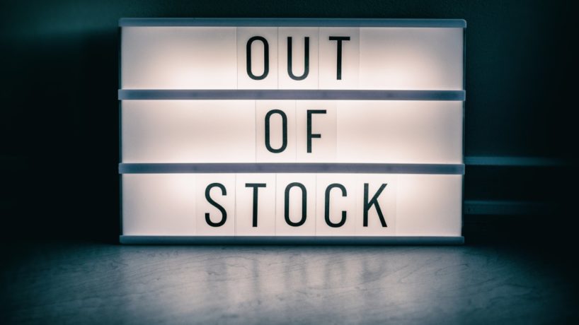 Covid-19 OUT OF STOCK store lightbox sign showing text message for shortage of PPE medical supplies. Coronavirus panic hoarding led to sold out shelves. shortage of hand sanitizer, mask products.