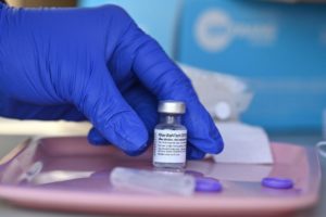 A nurse reaches for a vial of Pfizer-BioNTech Covid-19 vaccine at a pop up vaccine clinic in the Arleta neighborhood of Los Angeles, California, August 23, 2021.