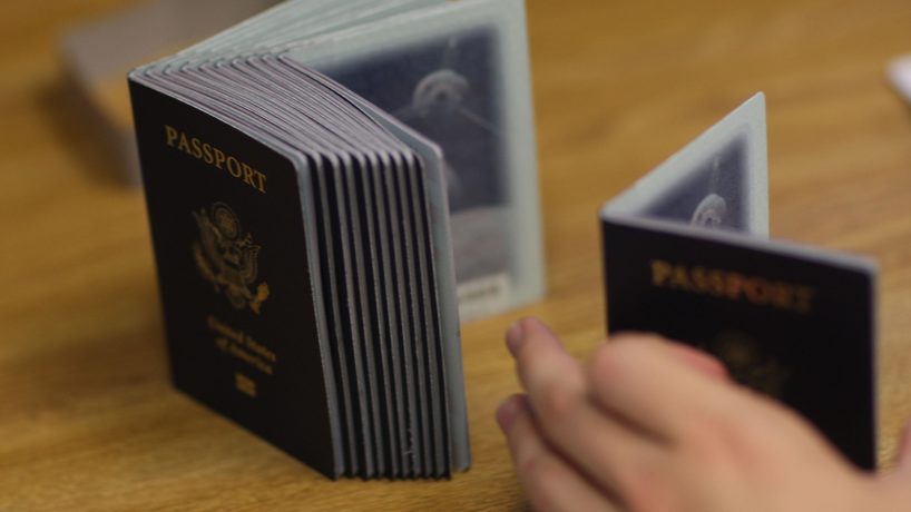 A Passport Processing employee uses a stack of blank passports to print a new one at the Miami Passport Agency June 22, 2007 in Miami, Florida.