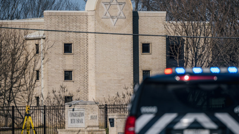 A law enforcement vehicle sits in front of the Congregation Beth Israel synagogue