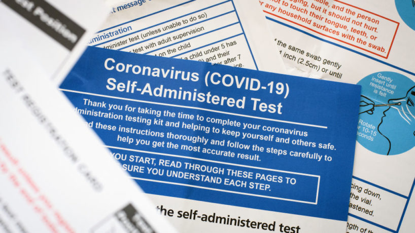 The documentation and instructions from a COVID-19 self-administered test kit.