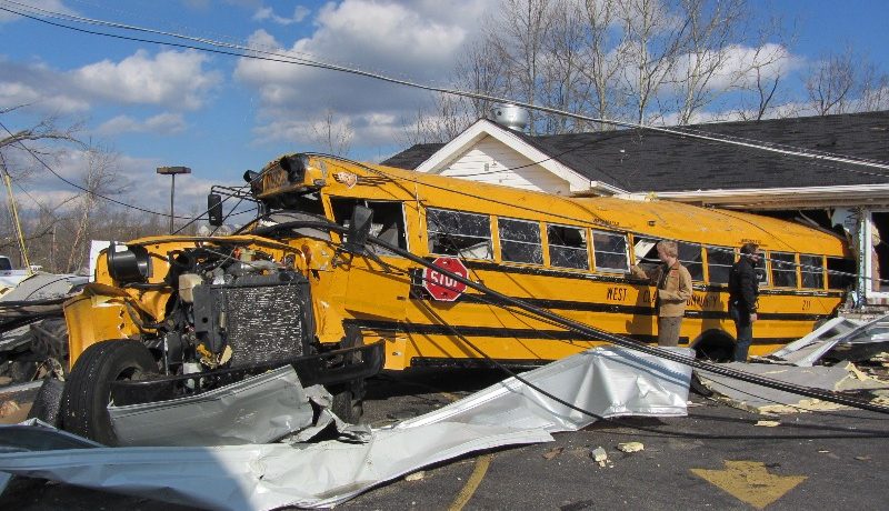 A school bus backed into a restaurant, damaged by a tornado