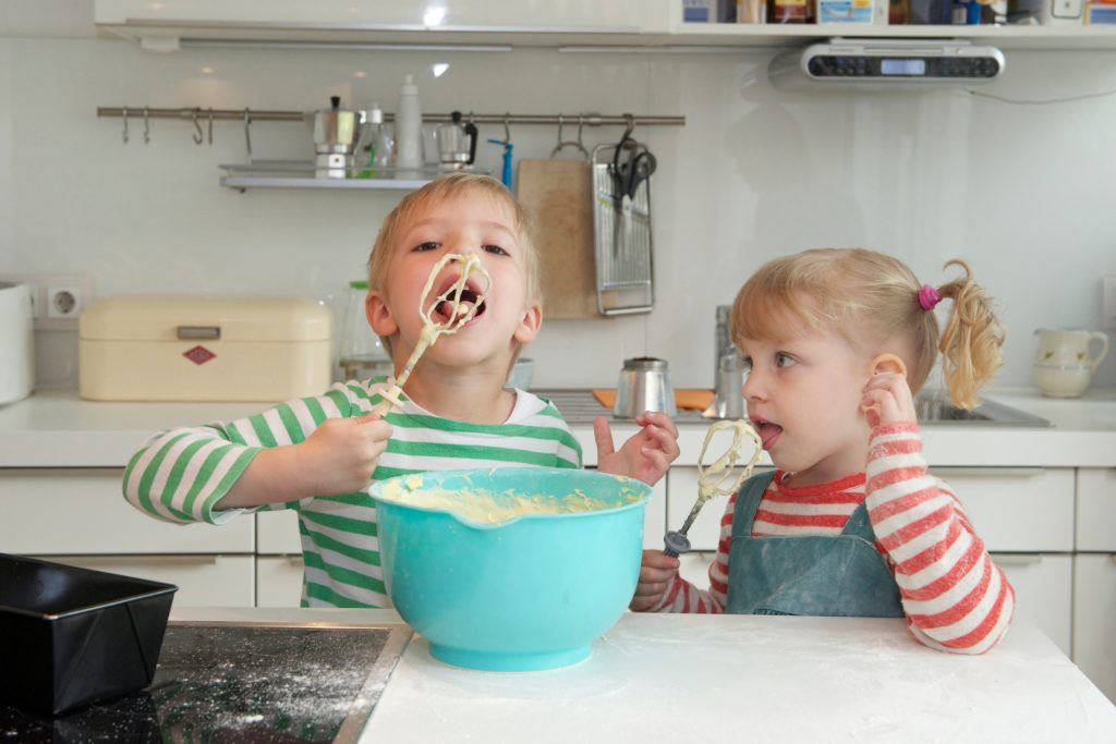 kids playing in the kitchen with a mixer