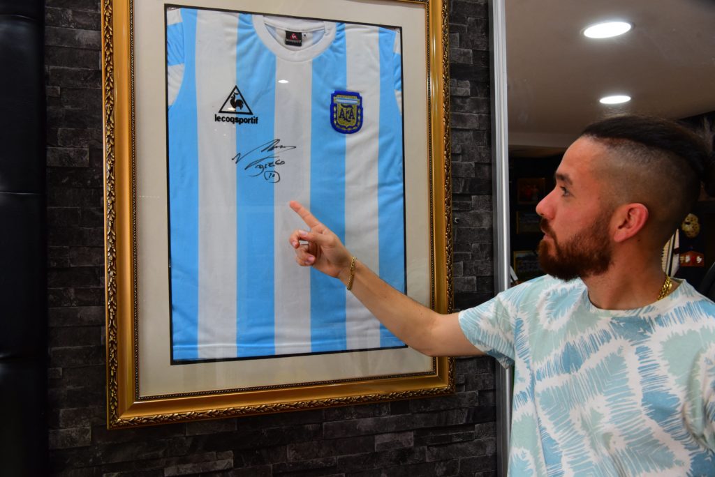 soccer star showing autographed jersey