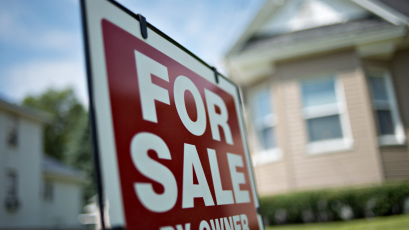 for sale sign in front of home