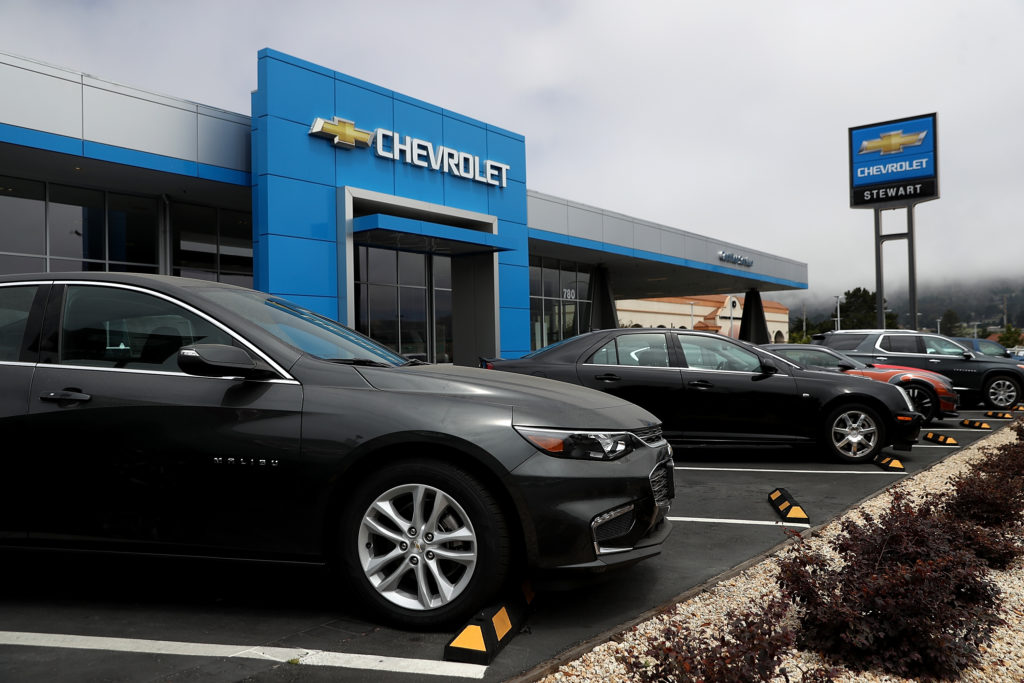 A Chevrolet Malibu is displayed at a Chevrolet dealership