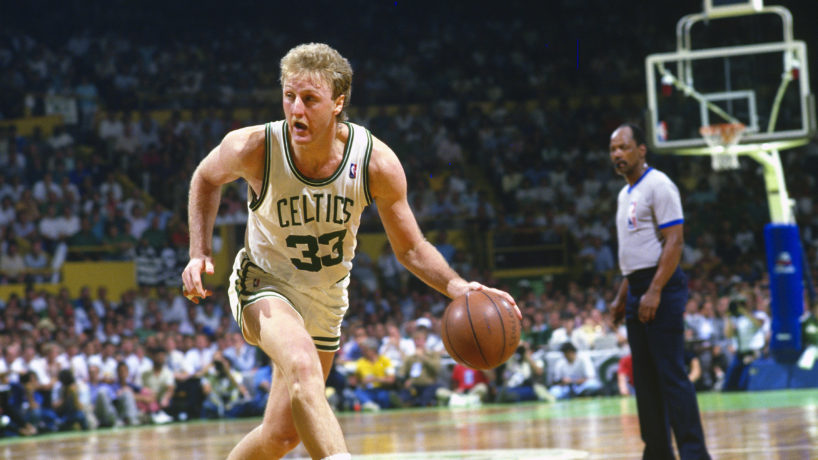 Larry Bird #33 of the Boston Celtics dribbles the ball