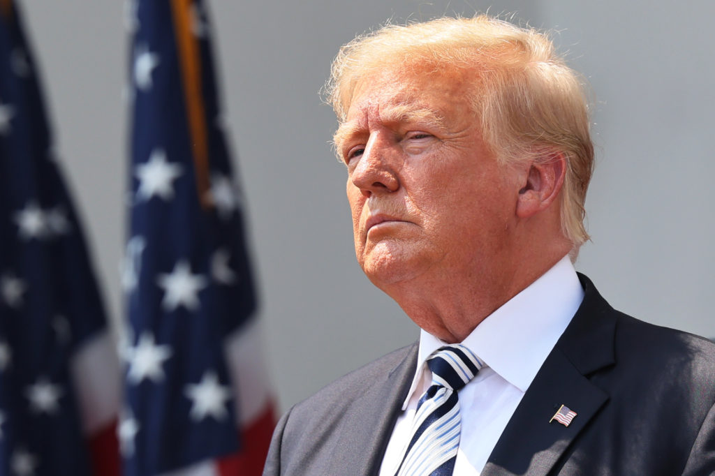 U.S. President Donald Trump looks on during a press conference 