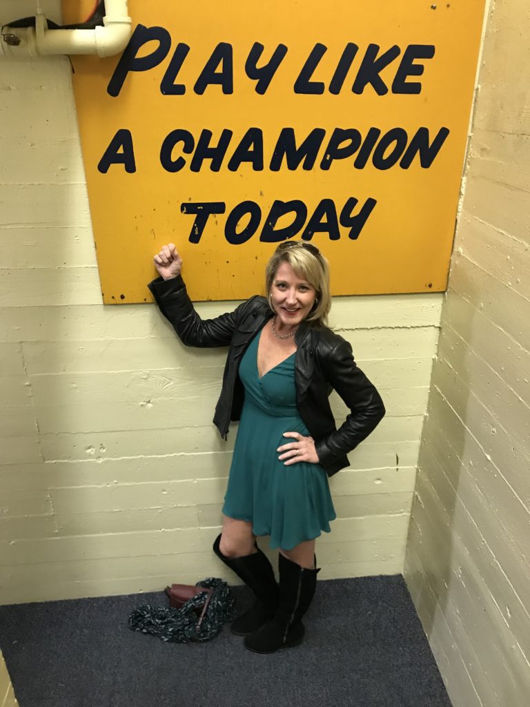 woman in front of "Play like a champion today" sign at Notre Dame University