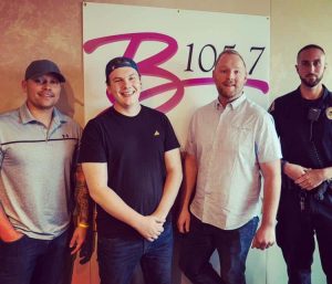 Sean Copeland pictured standing next to Lawrence police officers