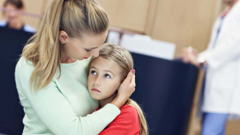 Picture of little girl crying while her mother comforts her