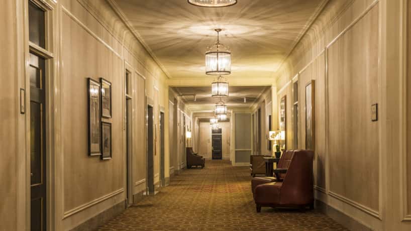 a hotel hallway / gets from the elevator / over to your room