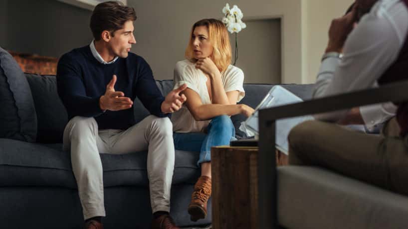 Couple arguing during therapy session with psychologist
