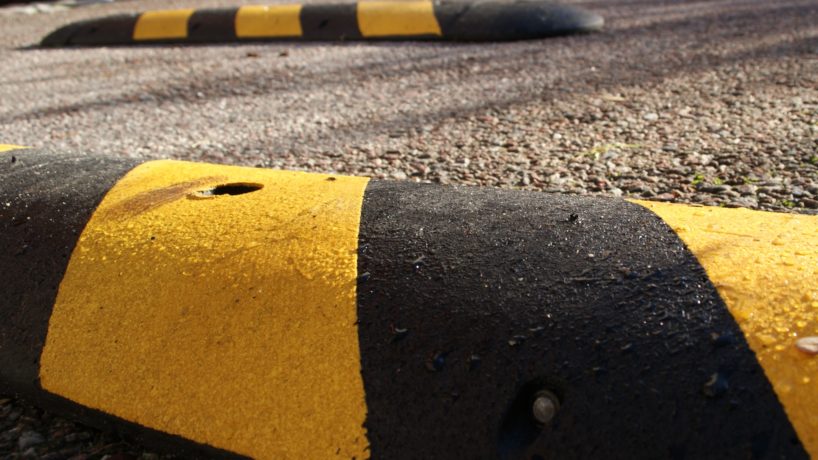 Speedbumps on a sunny morning. Placed on pavement to slow down speed of motorbikes, mopeds, cars and bicycles.
