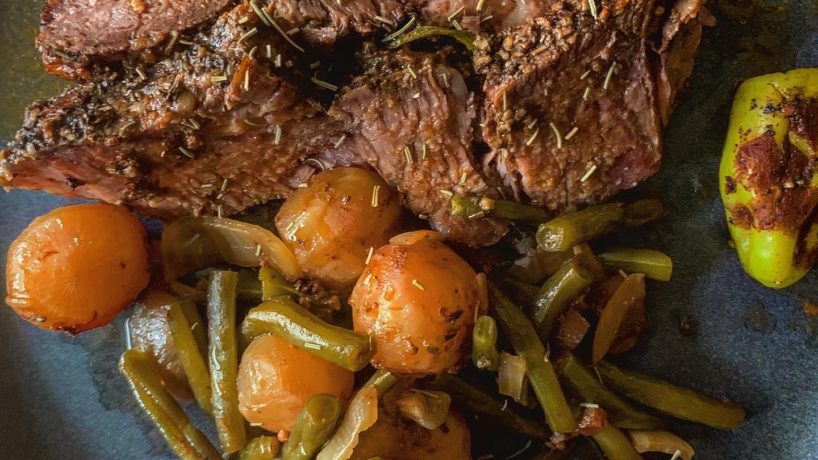 a pot roast plated with green beans