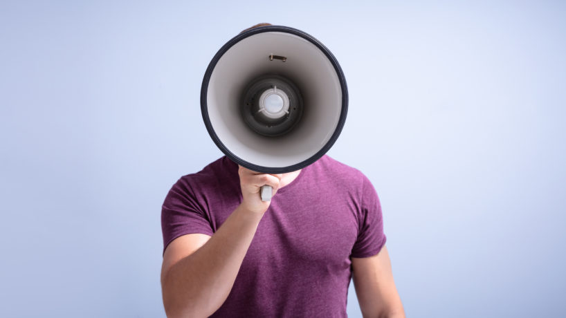 Man Shouting Through A Megaphone