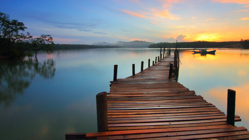bridge over a sunset lake