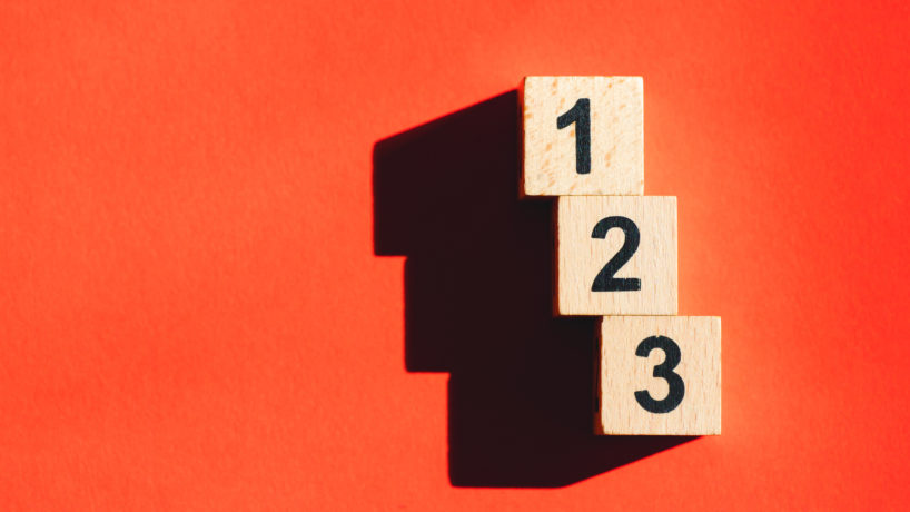 Wooden block number using as business and financial concept - Orange background