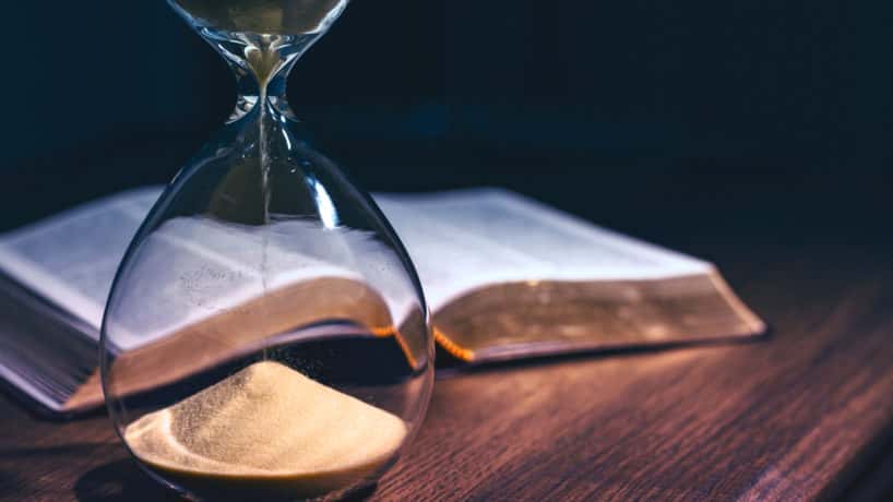 Hourglass and open bible