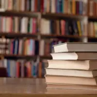 close-up-of-books-on-desk-in-library