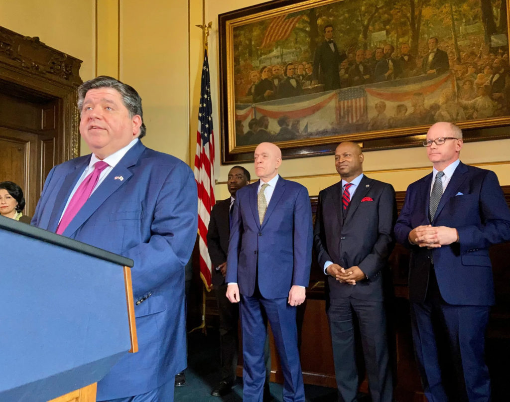 Gov. J.B. Pritzker announces a debt-reduction package approved by the General Assembly Thursday, March 24, 2022, in Springfield, Ill. Directly behind Pritzker at the announcement, are House Majority Leader Greg Harris, D-Chicago, from left, House Speaker Emanuel “Chris” Welch, D-Hillside, and Senate President Don Harmon, D-Oak Park. The legislation which shores up a depleted unemployment fund, pays down overdue bills in employee group health insurance and makes an advance payment on underfunded pension accounts came on a day that the respected, nonpartisan Civic Federation released a favorable review of Pritzker’s budget proposal because of its cautious approach. (AP Photo/John O’Connor)