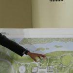 FILE - Former President Barack Obama points to a rendering for the former president's lakefront presidential center at a community event at the South Shore Cultural Center in Chicago on May 3, 2017. A federal judge on Tuesday, March 29, 2022, has dismissed a lawsuit that sought to prevent the construction of the Obama Presidential Center in a park on Chicago's South Side. (AP Photo/Nam Y. Huh, File)
