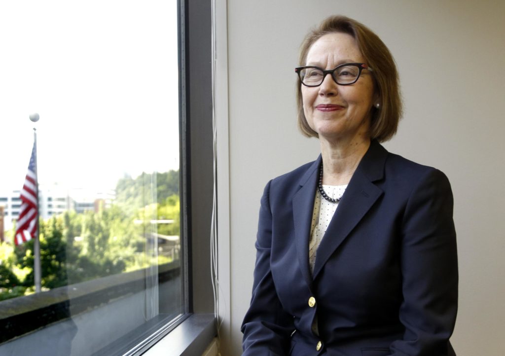 FILE - In this July 13, 2016 file photo, Oregon Attorney General Ellen Rosenblum poses for a photo at her office in Portland, Ore. The state of Oregon has sued an Illinois-based COVID-19 testing company, saying its owners took millions of dollars in federal funds and insurance money for themselves and boasted about buying a mansion and expensive sports cars. Rosenblum sued the Center for Covid Control, or CCC, and its testing partner, Doctors Clinical Laboratory, for deceptively marketing testing services and for violating Oregon's Unlawful Trade Practices Act. (AP Photo/Don Ryan, File)