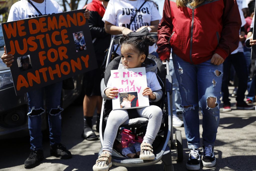 FILE - In this Saturday, May 1, 2021 file photo, Ailani Alvarez, 2, daughter of Anthony Alvarez who was shot by the police, holds a sign reading "I miss my daddy" during a protest in Chicago. Chicago police officers will no longer be allowed to chase people on foot simply because they run away or give chase over minor offenses, the department said Tuesday, June 21, 2022, more than a year after two foot pursuits ended with officers fatally shooting a 13-year-old boy and 22-year-old man. (AP Photo/Shafkat Anowar, File)