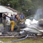 This photo from video by KFVS-TV shows people working the scene of a house explosion in Wyatt Mo., early Monday, Aug. 15, 2022. The house explosion in southeast Missouri has left several people injured and a neighboring home in flames, authorities say. (KFVS TV via AP)