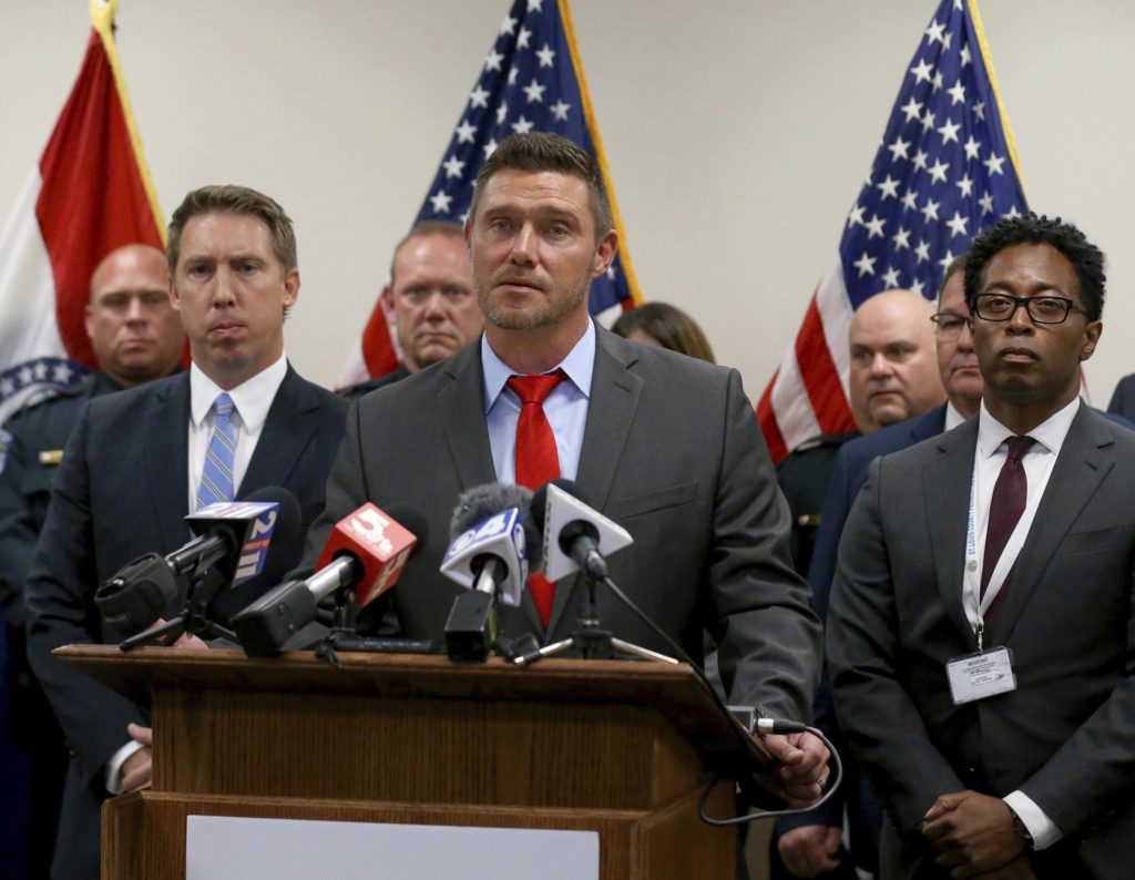 St. Charles County prosecutor Tim Lohmar, center, speaks at a news conference on Monday, Sept. 19, 2022, flanked by Lincoln County prosecutor Michael Wood, left, and St. Louis County prosecutor Wesley Bell at the St. Louis County government building in Clayton, Mo. St. Louis-area prosecutors say a convicted murderer serving a life sentence for killing a man in 1995 has confessed to strangling four women five years earlier. Prosecutors from Lincoln, St. Charles and St. Louis counties, which was where the victims’ bodies were found, said that Gary Muehlberg, a 73-year-old inmate at the Potosi Correctional Center in southeastern Missouri, confessed to the 1990 killings. (Christian Gooden/St. Louis Post-Dispatch via AP)